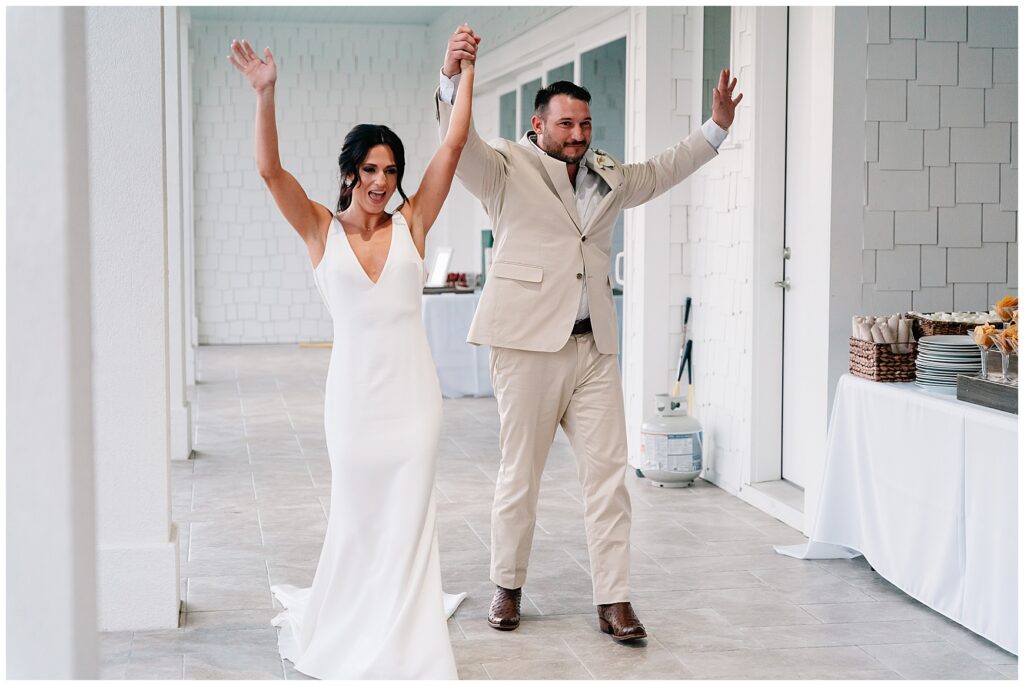 bride and groom entering their wedding reception