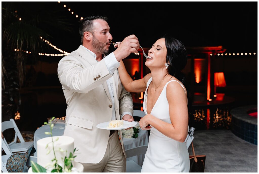 bride and groom eating wedding cake