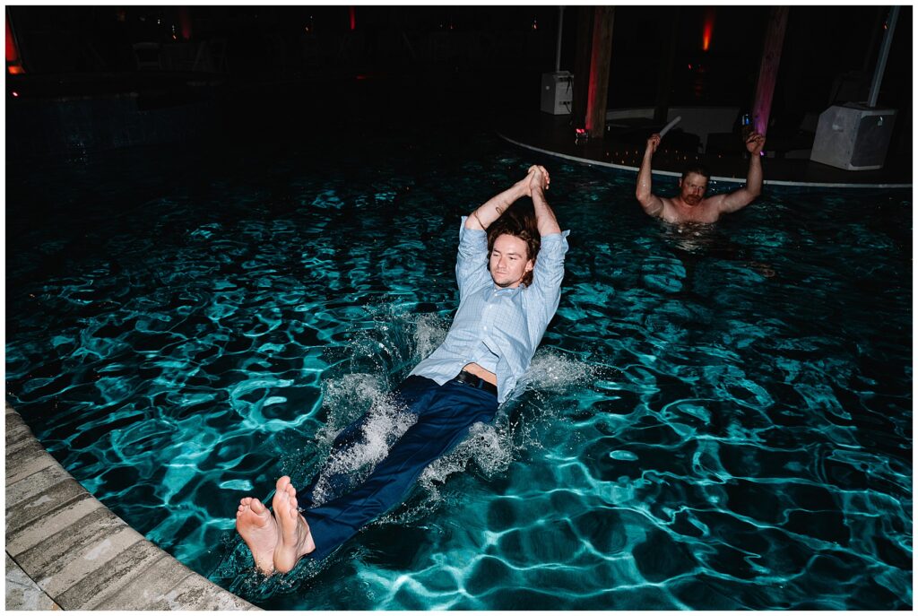 Guests jumping in the pool at a wedding reception