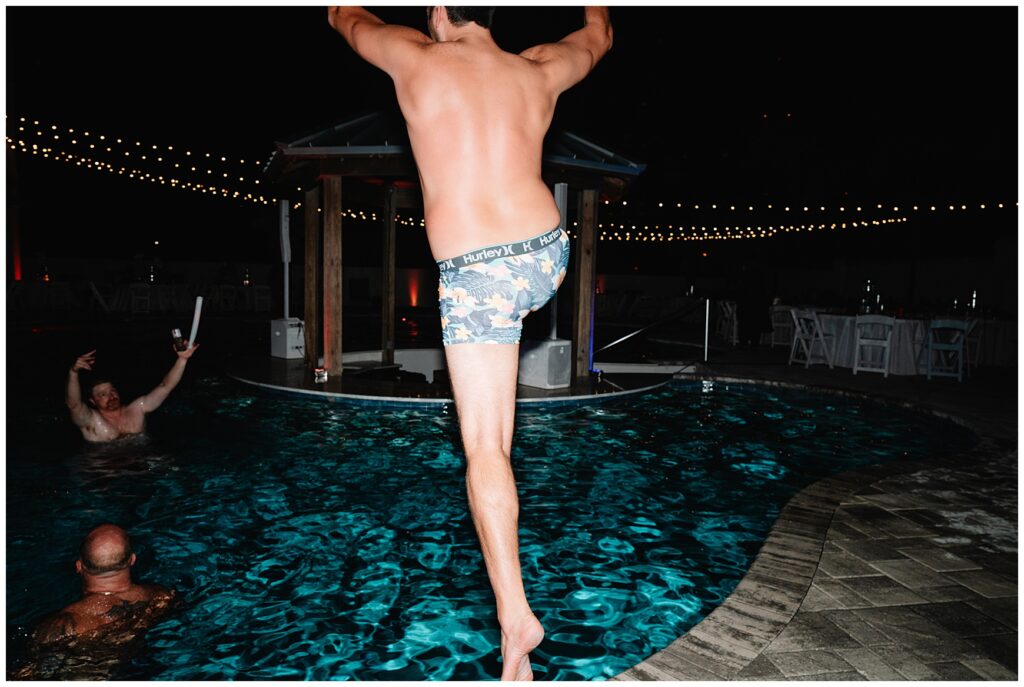 guests jumping in a pool at a wedding